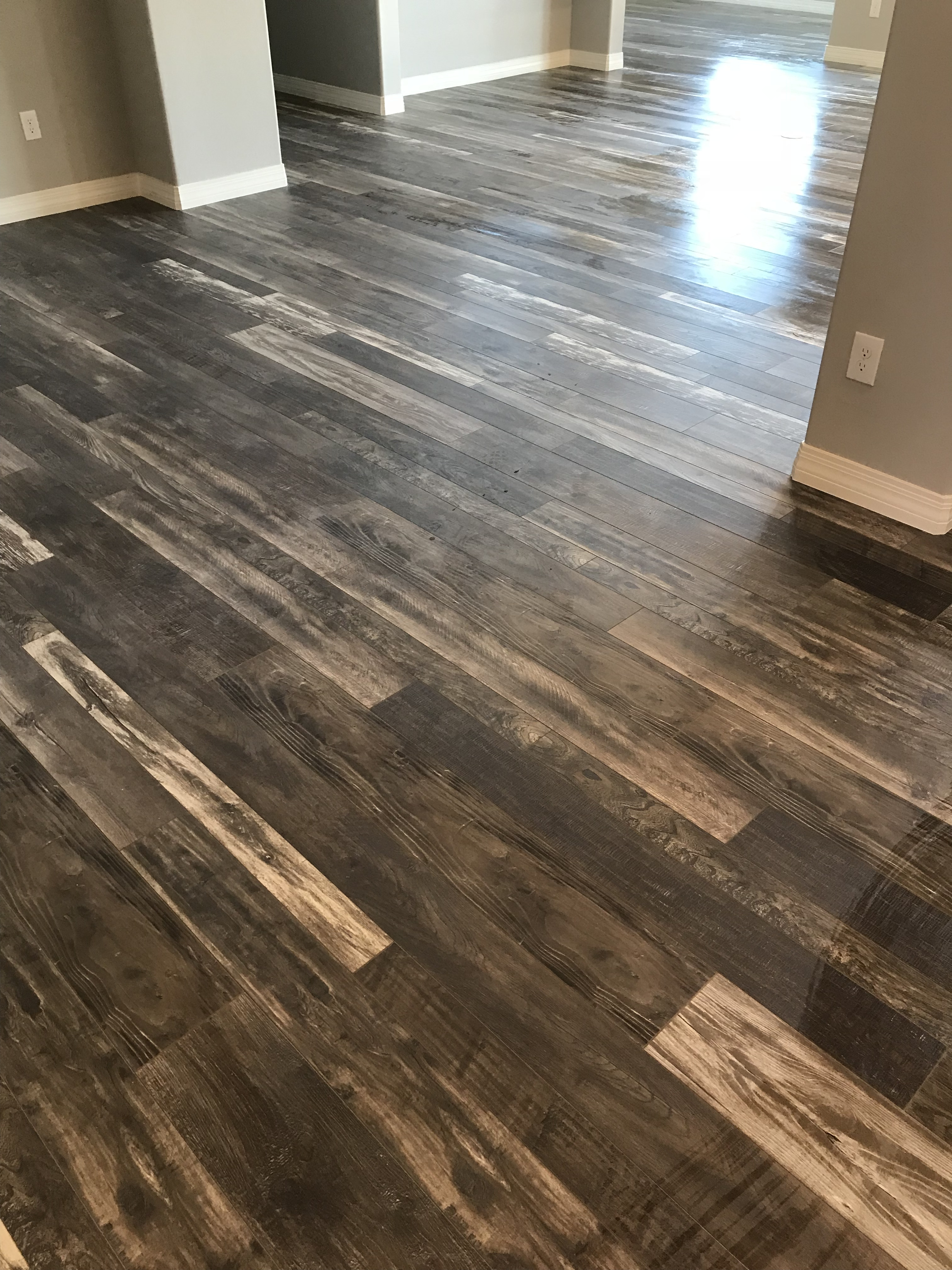Rustic wood-look laminate flooring installation in a Tucson home